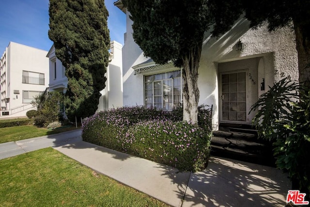 entrance to property with a lawn