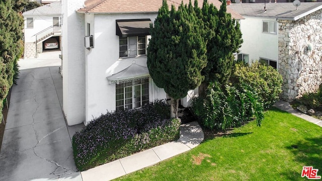 view of side of home featuring a lawn