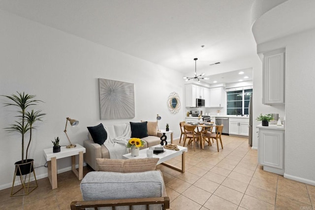 tiled living room featuring a notable chandelier and sink