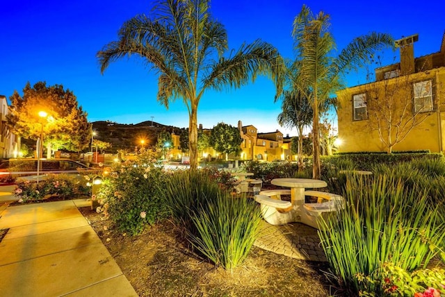 yard at dusk featuring a patio