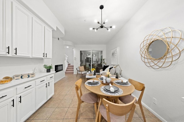 dining room featuring an inviting chandelier and light tile patterned flooring