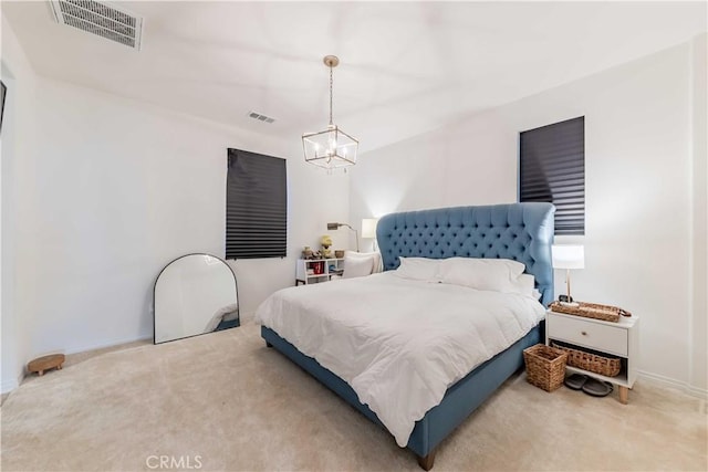 bedroom with an inviting chandelier and carpet