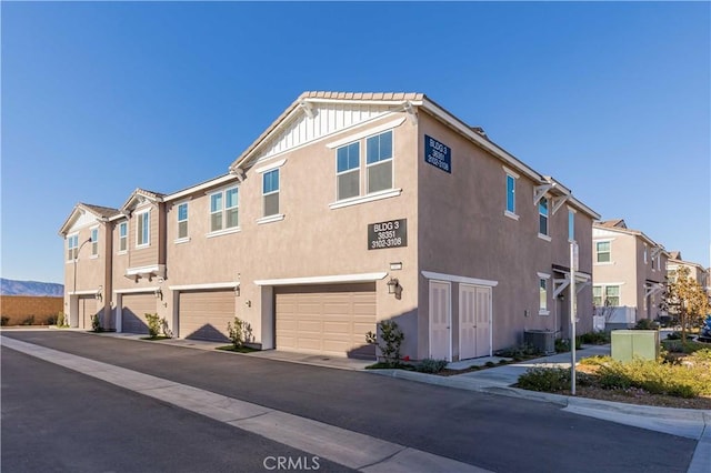 exterior space featuring cooling unit and a garage