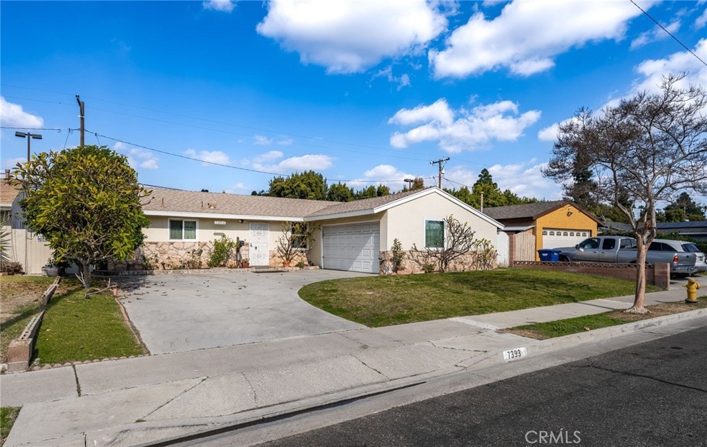 ranch-style house featuring a garage and a front lawn