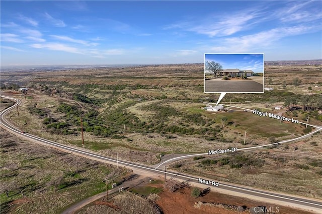 birds eye view of property with a rural view