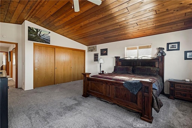 carpeted bedroom with wood ceiling, vaulted ceiling, and a closet