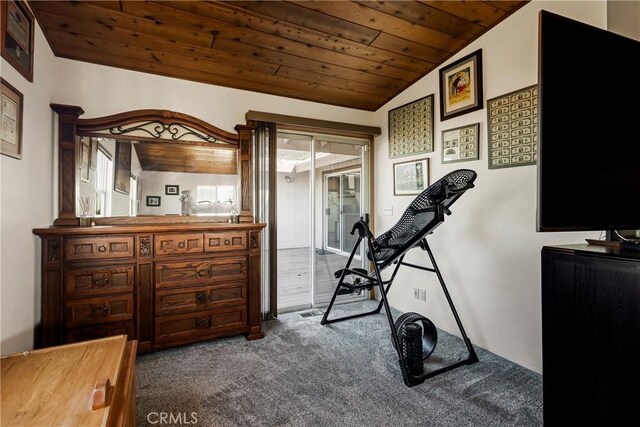 exercise area featuring lofted ceiling, wooden ceiling, and dark colored carpet