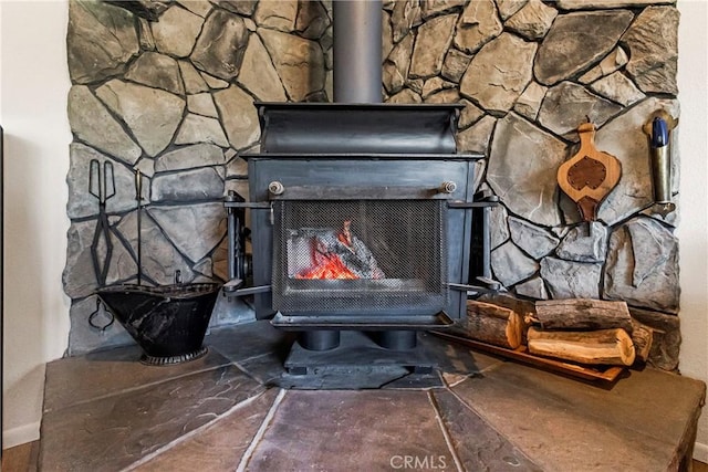 details featuring a fireplace and a wood stove