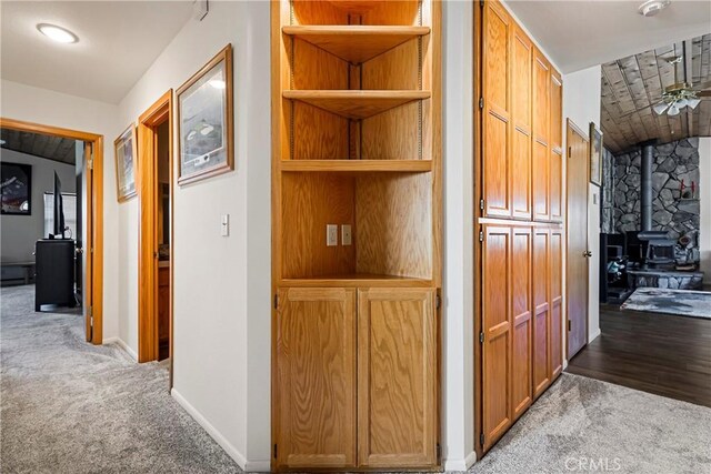 corridor with vaulted ceiling and carpet