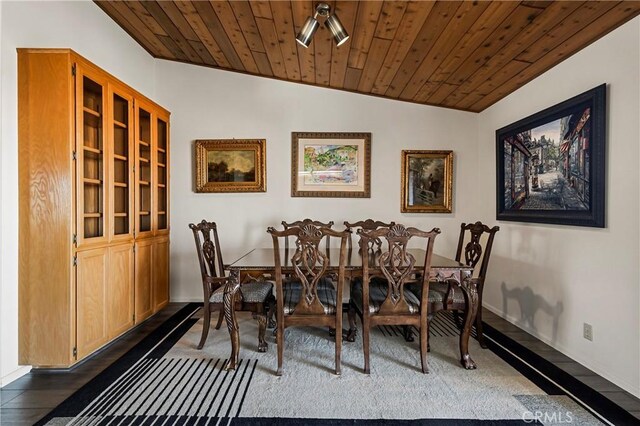 dining space with vaulted ceiling, wooden ceiling, and dark hardwood / wood-style floors