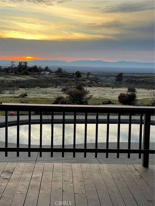 deck at dusk with a mountain view