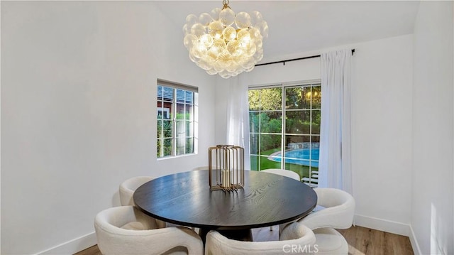 dining room featuring hardwood / wood-style floors and an inviting chandelier