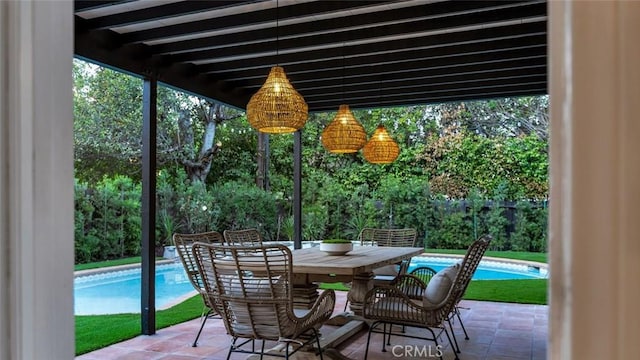 view of patio / terrace with outdoor dining area and an outdoor pool