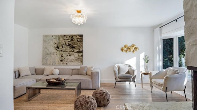 living room with light hardwood / wood-style floors and a chandelier