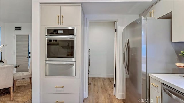 kitchen featuring appliances with stainless steel finishes and light hardwood / wood-style floors