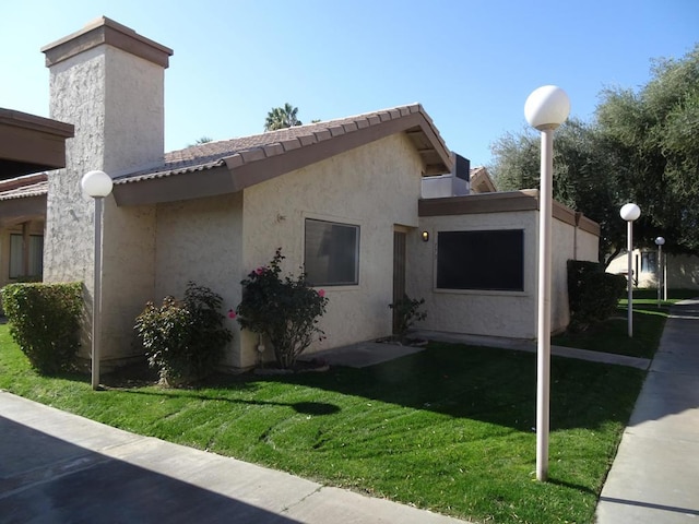 view of home's exterior with a lawn