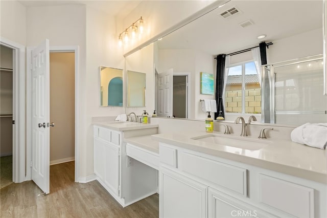 bathroom featuring vanity, hardwood / wood-style flooring, and walk in shower