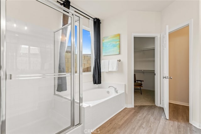 bathroom featuring separate shower and tub and hardwood / wood-style floors