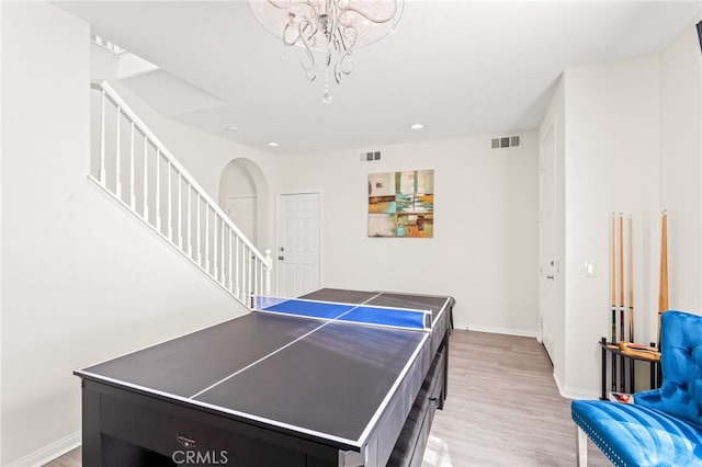 playroom with a chandelier and light hardwood / wood-style flooring