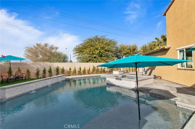 view of swimming pool featuring a patio and a jacuzzi