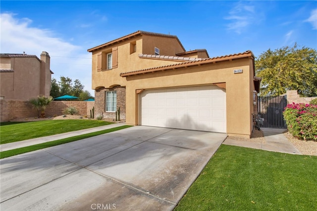 mediterranean / spanish house featuring a garage and a front yard