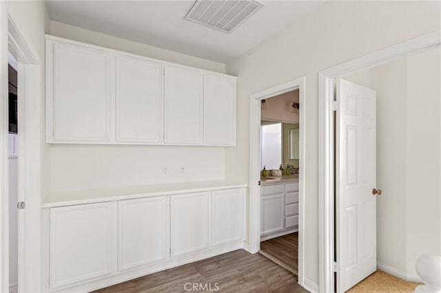 corridor with hardwood / wood-style floors