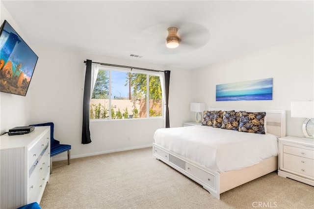 bedroom with ceiling fan and light colored carpet