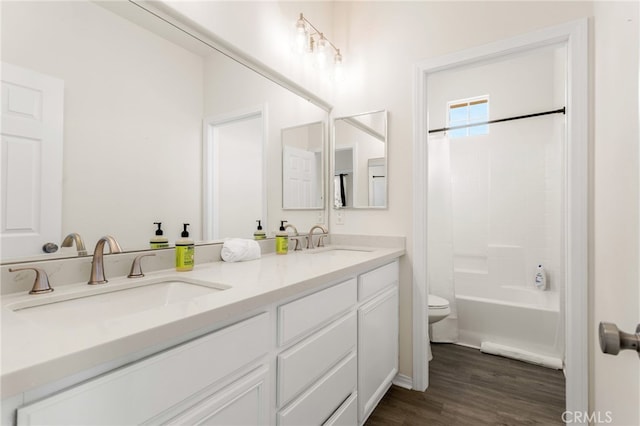 full bathroom with vanity, hardwood / wood-style floors, shower / bath combination with curtain, and toilet