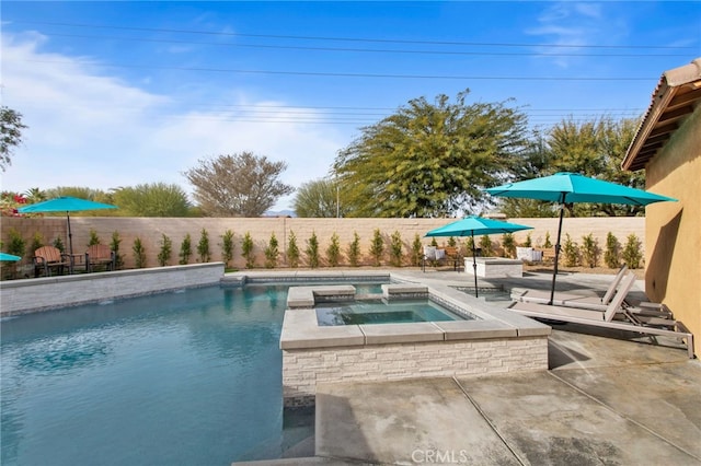 view of swimming pool featuring an in ground hot tub and a patio