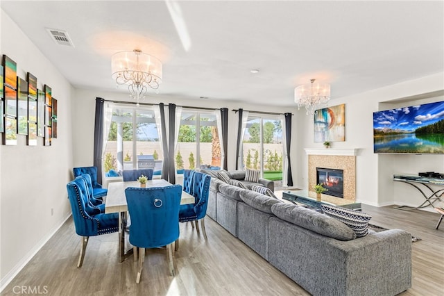 living room featuring a chandelier and light hardwood / wood-style flooring