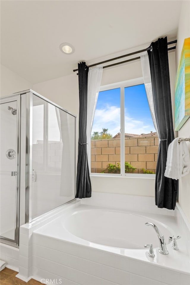 bathroom with shower with separate bathtub