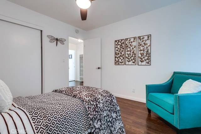 bedroom with ceiling fan, dark hardwood / wood-style flooring, and a closet