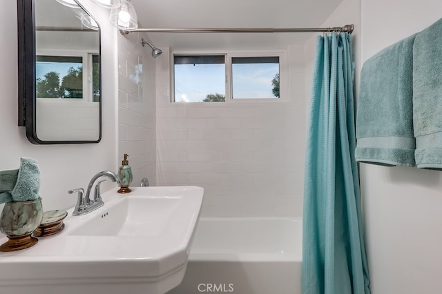 bathroom featuring sink and shower / bath combination with curtain