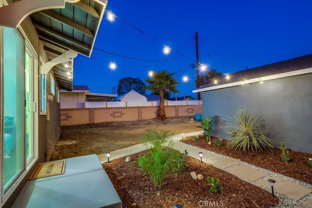 view of yard at twilight