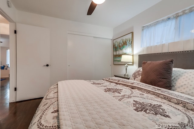 bedroom featuring wood-type flooring, ceiling fan, and a closet