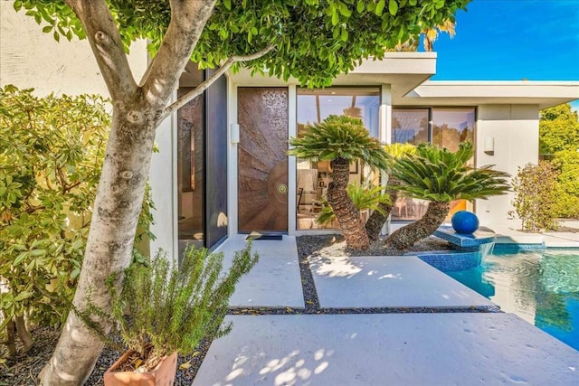 entrance to property featuring a patio