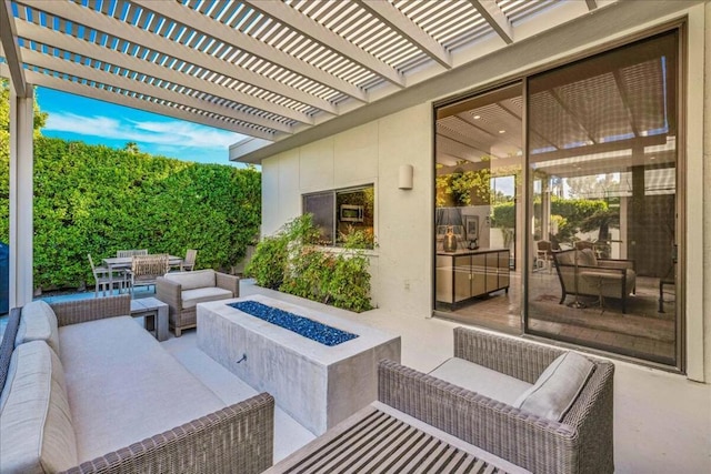 view of patio / terrace with an outdoor living space with a fire pit and a pergola