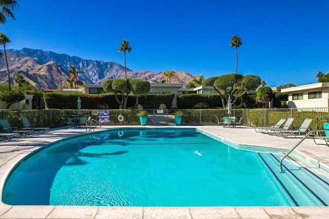 view of pool featuring a mountain view and a patio area