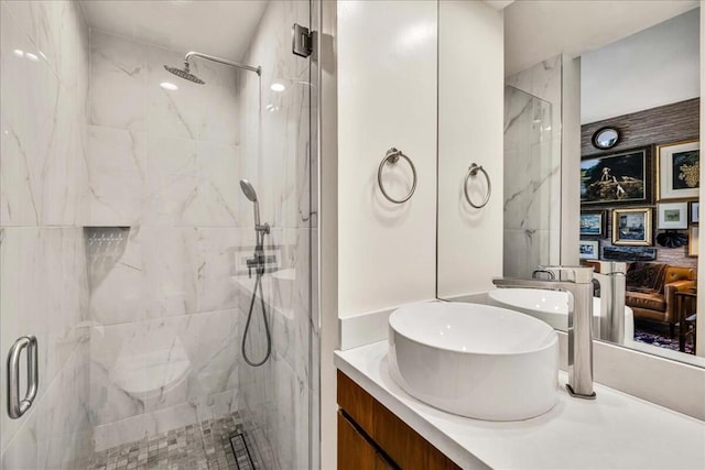 bathroom with vanity and a shower with shower door