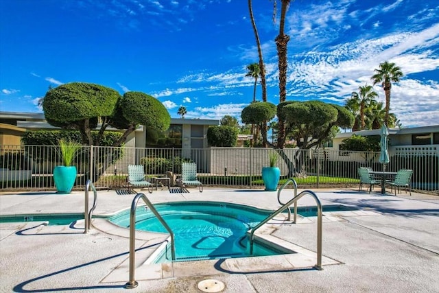 view of pool featuring a patio area and a hot tub