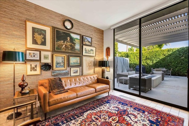 sitting room featuring floor to ceiling windows and light tile patterned floors