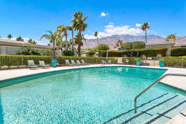 view of swimming pool with a mountain view