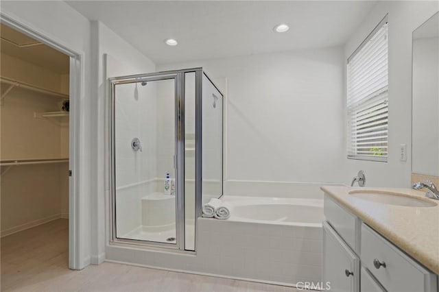 bathroom with vanity and plus walk in shower