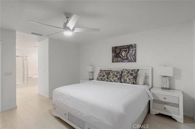 bedroom featuring ceiling fan, ensuite bathroom, and light hardwood / wood-style floors