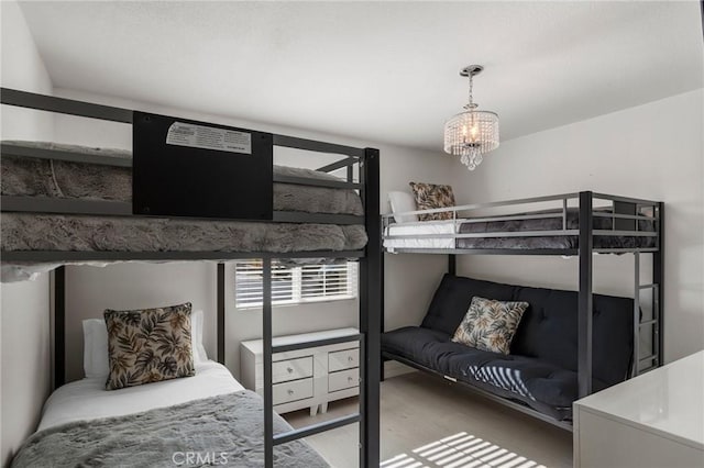 bedroom with hardwood / wood-style flooring and a chandelier