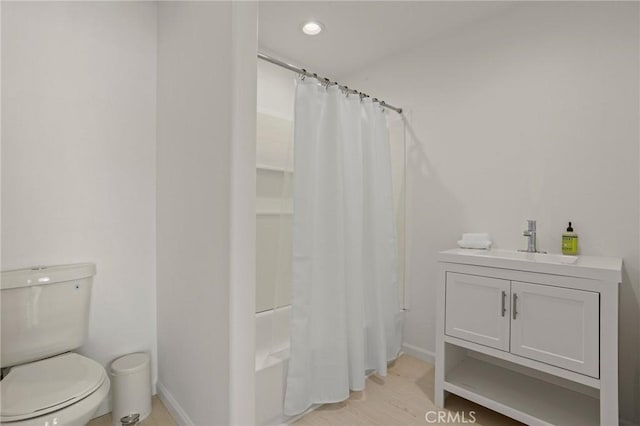 full bathroom with vanity, toilet, and shower / bath combo with shower curtain