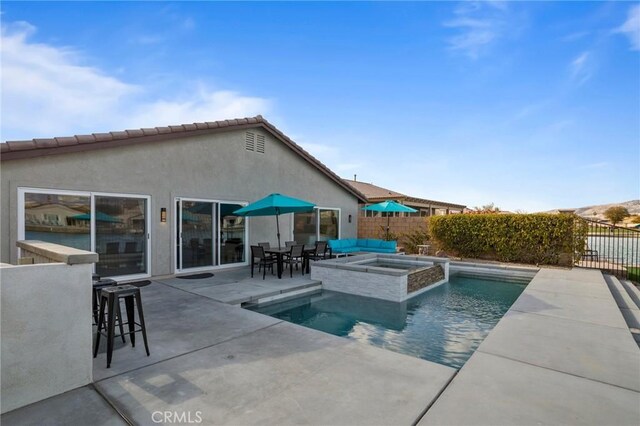 view of pool featuring an in ground hot tub, a bar, and a patio