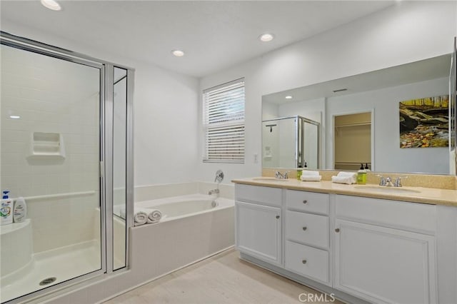 bathroom featuring vanity, hardwood / wood-style flooring, and independent shower and bath