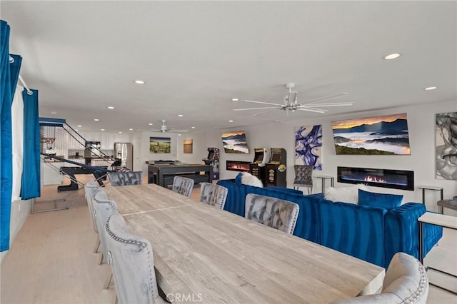 dining room with ceiling fan and light hardwood / wood-style floors