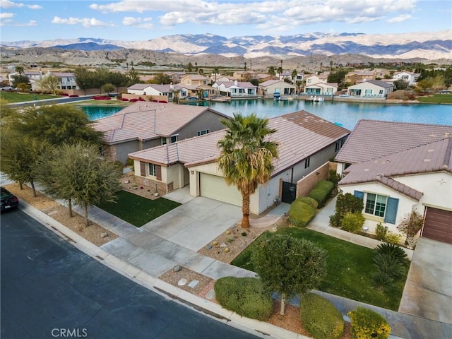 birds eye view of property with a water and mountain view